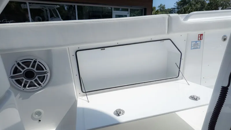 Slide: The Image of Interior view of a 2026 Everglades 285 Center Console boat, featuring a speaker and storage area. - 12