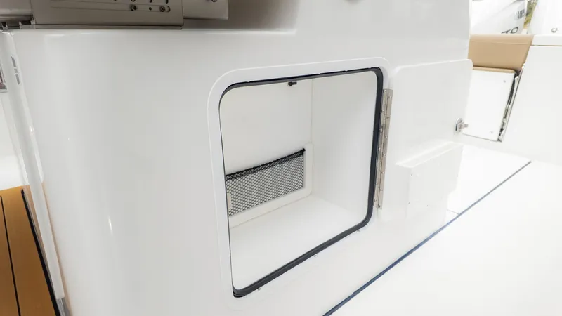 Slide: The Image of Storage compartment with netting in the Everglades 335 Center Console boat. - 14