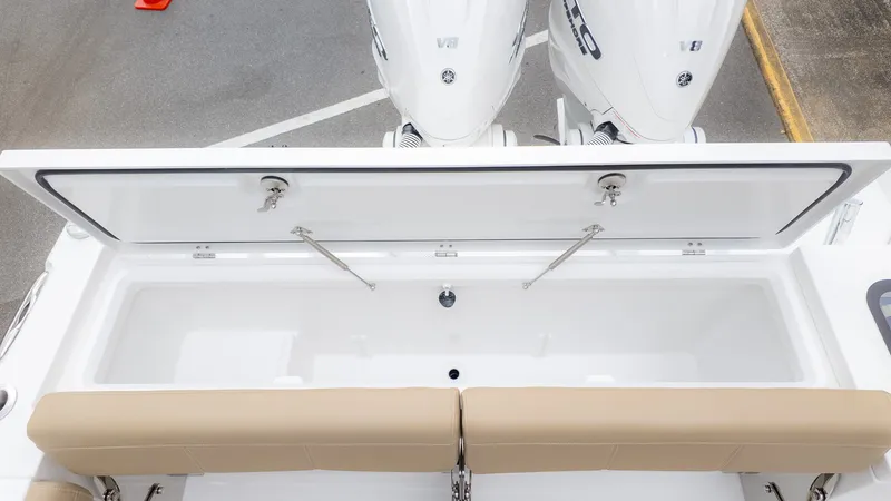 Slide: The Image of Rear view of a boat with two engines and a large white storage box. - 10
