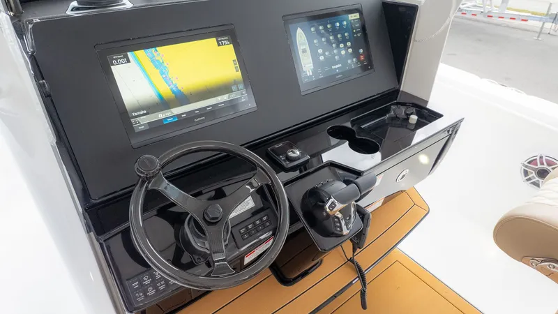 Slide: The Image of The image shows the cockpit of an Everglades 335 Center Console boat with modern navigation systems. - 26