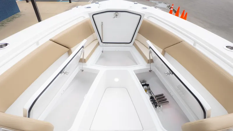 Slide: The Image of The image shows the bow of an Everglades 335 Center Console boat with beige seating and storage. - 18