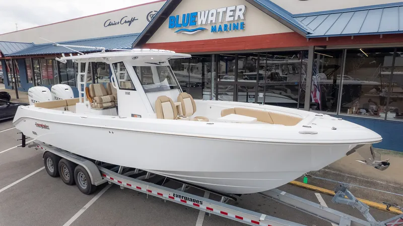 The Image of An Everglades 335 Center Console boat on a trailer in front of a marine store. - 1