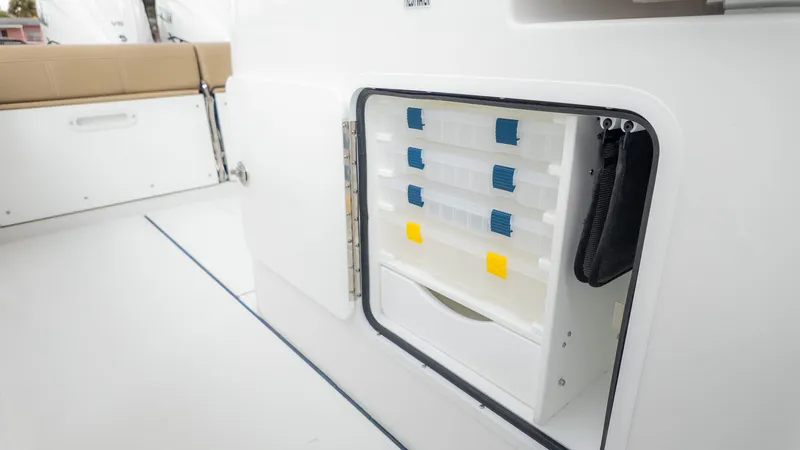 Slide: The Image of An open storage compartment on a boat with multiple drawers and compartments. - 24