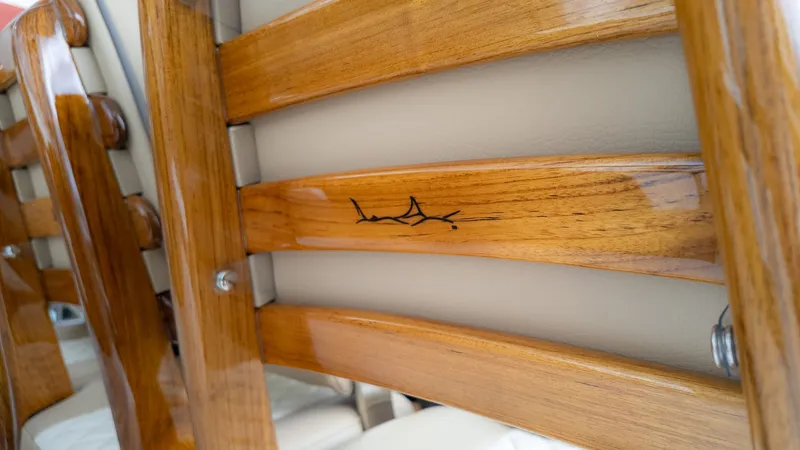 Slide: The Image of Close-up of polished wooden benches with beige upholstery on a boat. - 23