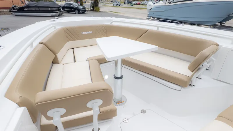 Slide: The Image of Interior view of an Everglades 335 Center Console boat with beige seating and a white table. - 15