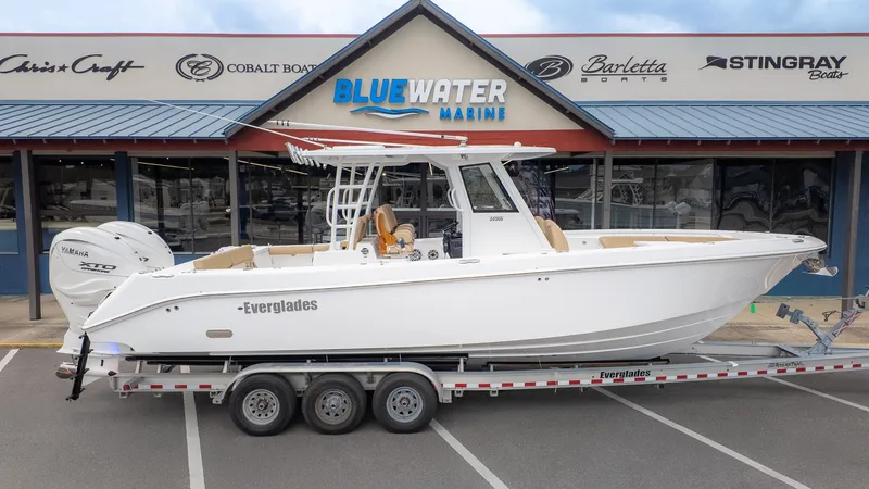 Slide: The Image of An Everglades 335 Center Console boat on a trailer in front of a marine store. - 32