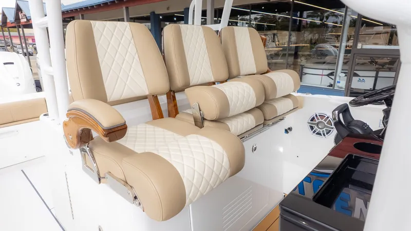 Slide: The Image of The 2026 Everglades 335 Center Console features beige, quilted seats with diamond patterns and armrests. - 22