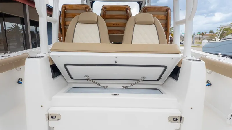 Slide: The Image of The 2026 Everglades 335 Center Console features an open bench seat with storage underneath. - 25