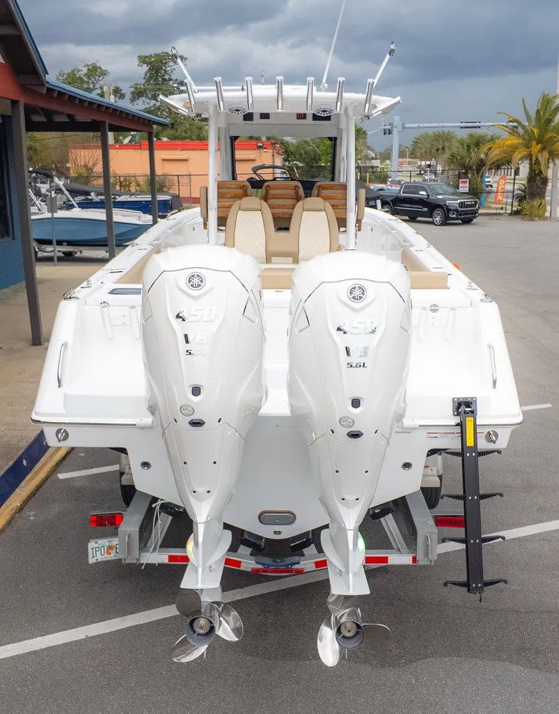 Slide: The Image of The image shows an Everglades 335 Center Console boat with twin outboard engines. - 3