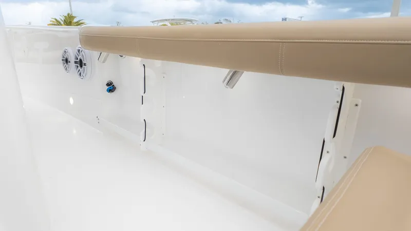 Slide: The Image of Close-up of seating area with speakers and grab handles on an Everglades 335 Center Console boat. - 10