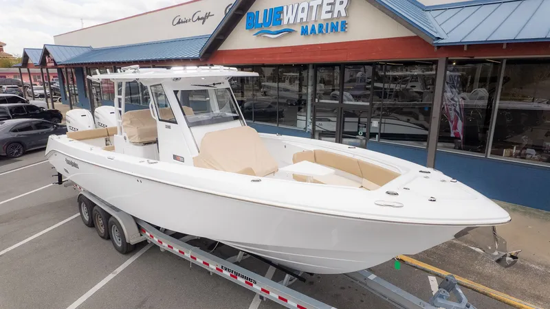 Slide: The Image of An Everglades 335 Center Console boat from 2026 on a trailer outside a marine store. - 32