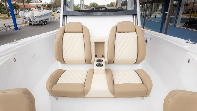 Slide: The Image of The 2026 Everglades 335 Center Console features beige and white seating with cup holders. - 18