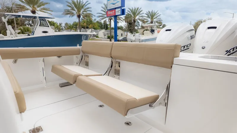 Slide: The Image of The 2026 Everglades 335 Center Console features beige seating and two outboard engines. - 6