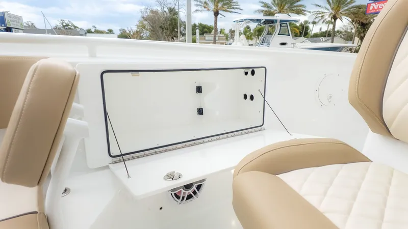 Slide: The Image of Interior view of an Everglades 335 Center Console boat with beige seating and storage area. - 20