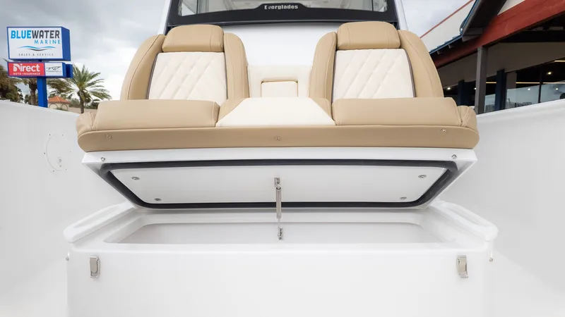 Slide: The Image of The 2026 Everglades 335 Center Console features beige seating with storage underneath. - 19