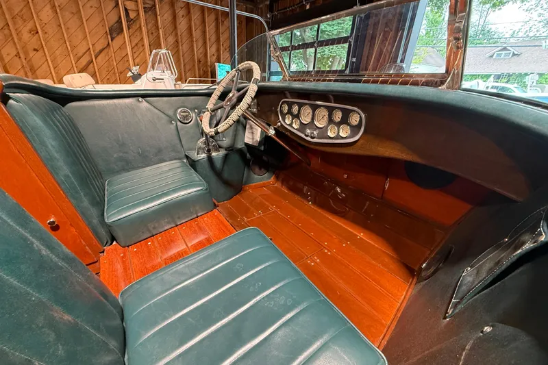 Slide: The Image of Interior of a 1996 Hacker-Craft Triple Cockpit Runabout with vintage dashboard and leather seats. - 11