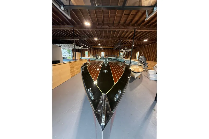 Slide: The Image of 1996 Hacker-Craft Triple Cockpit Runabout in a wooden garage setting. - 8