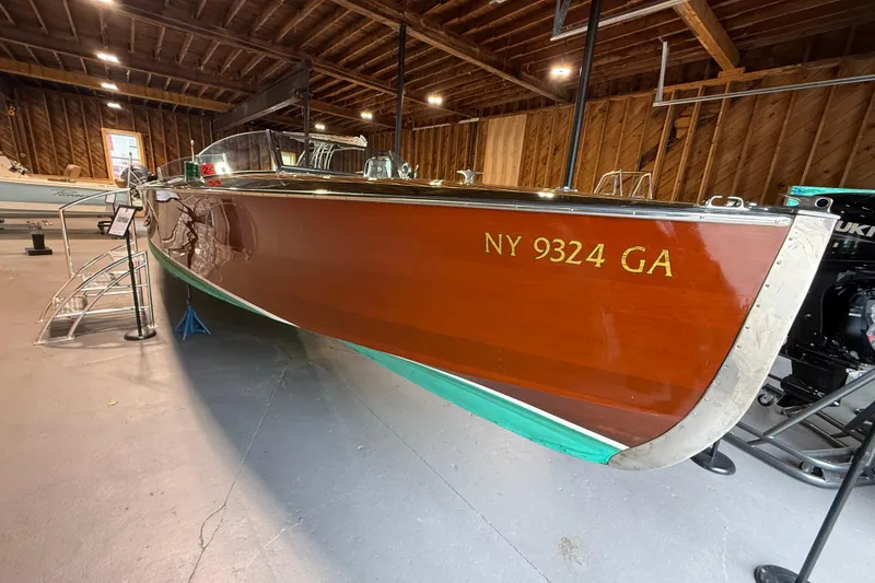 Slide: The Image of 1996 Hacker-Craft Triple Cockpit Runabout in wooden interior showroom, displaying registration NY 9324 GA. - 2