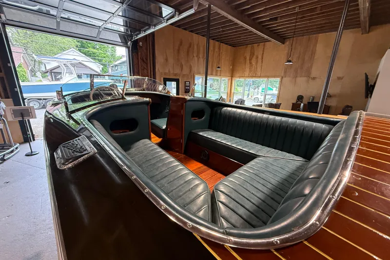 Slide: The Image of 1996 Hacker-Craft Triple Cockpit Runabout with luxurious leather seating in a wooden garage. - 12