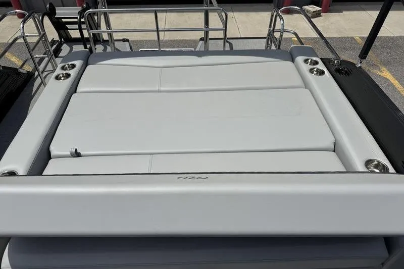 Slide: The Image of 2026 Manitou Encore 25 SL SHP boat with spacious sun deck and cup holders. - 14
