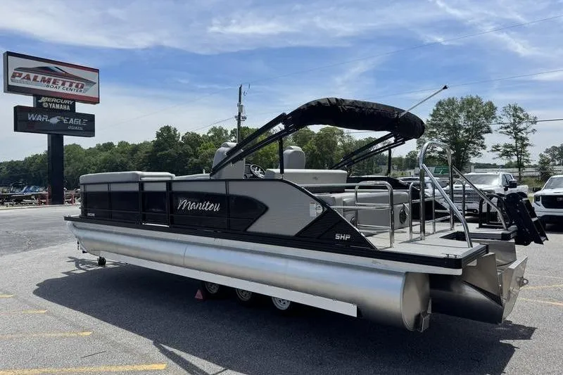 Slide: The Image of 2026 Manitou Encore 25 SL SHP pontoon boat displayed at dealership. - 6