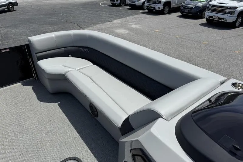Slide: The Image of 2026 Manitou Encore 25 SL SHP pontoon boat with spacious gray seating. - 11