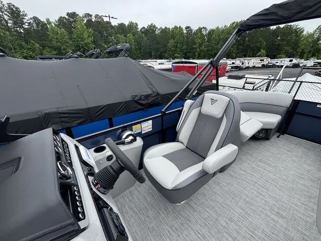 Slide: The Image of The image shows the cockpit of a Viaggio Lago V22U boat with gray and white seating. - 12