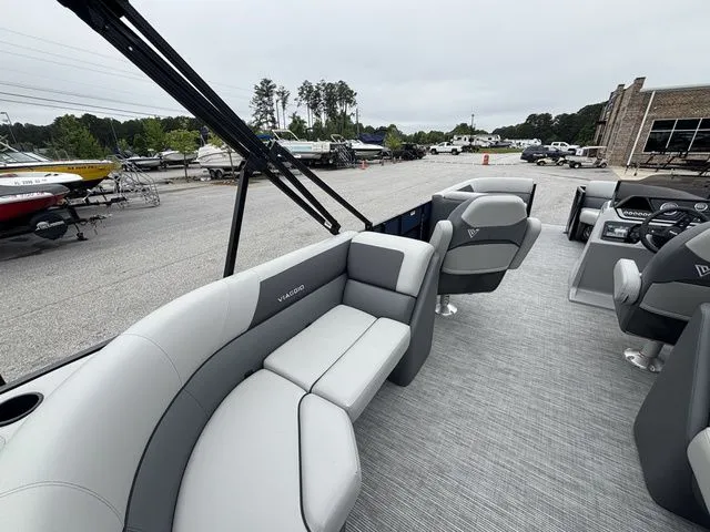 Slide: The Image of The image shows the interior of a Viaggio Lago V22U boat with gray seating and a helm station. - 21