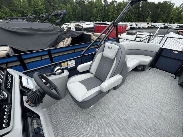 Slide: The Image of The image shows the cockpit of a Viaggio Lago V22U boat with gray seating and a helm station. - 27