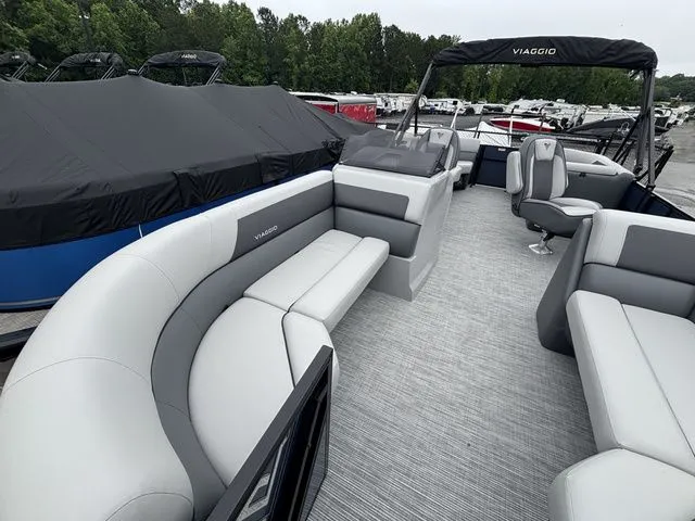 Slide: The Image of The image shows the interior of a Viaggio Lago V22U boat with gray seating and a helm station. - 8