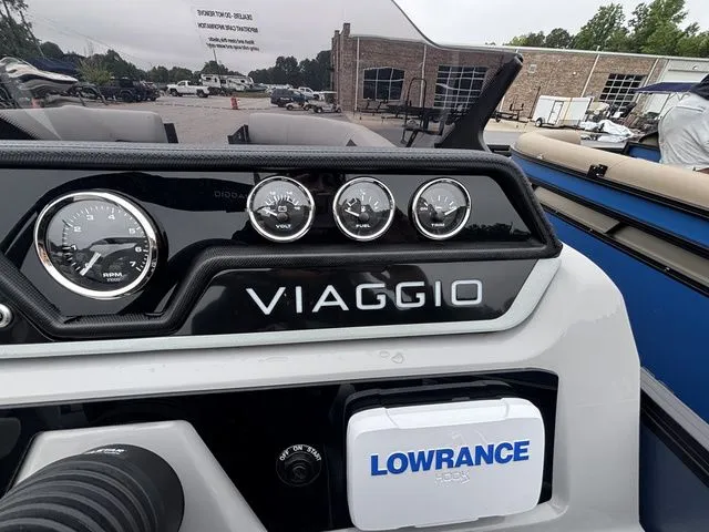 Slide: The Image of Close-up of a Viaggio Lago V22U dashboard with Lowrance device and gauges. - 29