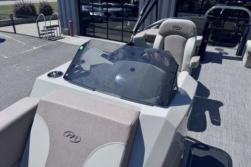 Slide: The Image of 2027 Manitou Aurora 23 RF SHP boat interior with seating and console. - 18