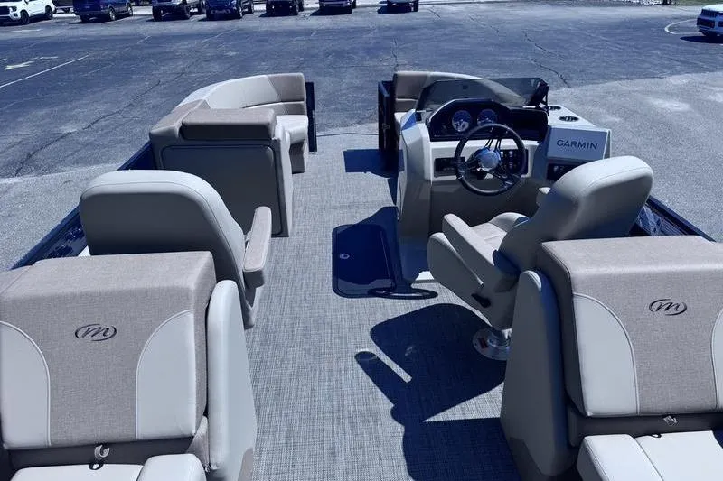 Slide: The Image of 2027 Manitou Aurora 23 RF SHP pontoon boat interior with seating and Garmin navigation. - 4