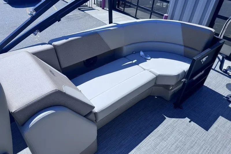 Slide: The Image of 2027 Manitou Aurora 23 RF SHP boat interior with plush seating and modern design. - 29