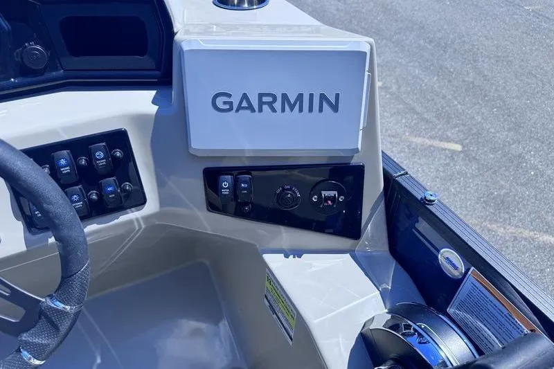 Slide: The Image of Dashboard of 2027 Manitou Aurora 23 RF SHP with Garmin navigation system. - 26