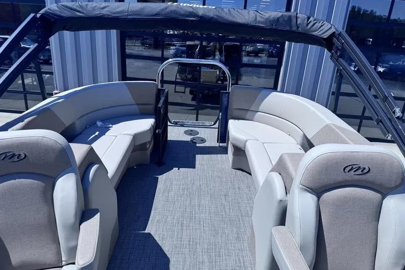 Slide: The Image of 2027 Manitou Aurora 23 RF SHP pontoon boat interior with seating and canopy. - 28