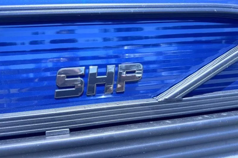 Slide: The Image of 2027 Manitou Aurora 23 RF SHP emblem on sleek blue surface. - 11