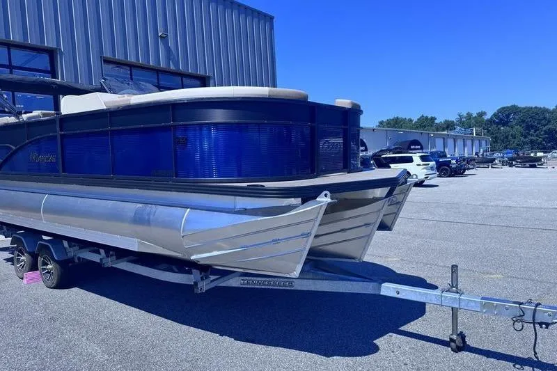 Slide: The Image of 2027 Manitou Aurora 23 RF SHP pontoon boat on trailer in parking lot. - 5