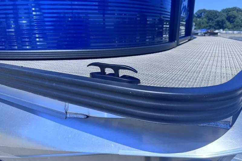 Slide: The Image of Close-up of 2027 Manitou Aurora 23 RF SHP boat deck with cleat and blue paneling. - 13