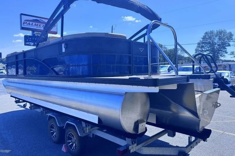 Slide: The Image of 2027 Manitou Aurora 23 RF SHP pontoon boat on trailer, outdoor display. - 15