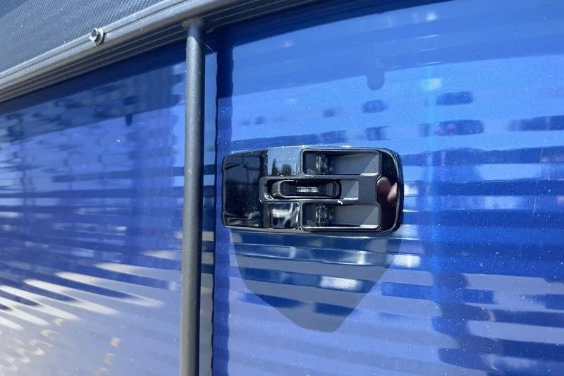 Slide: The Image of Close-up of a 2027 Manitou Aurora 23 RF SHP boat latch on a blue surface. - 20