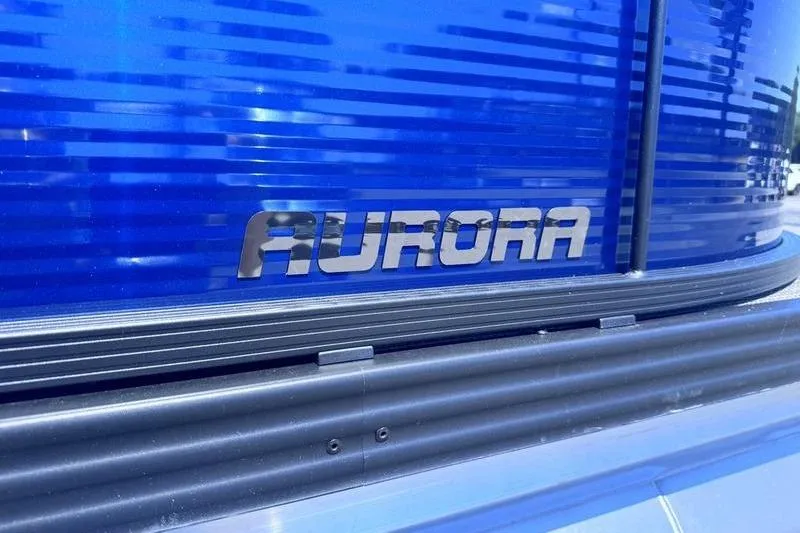 Slide: The Image of Close-up of 2027 Manitou Aurora 23 RF SHP logo on blue surface. - 23
