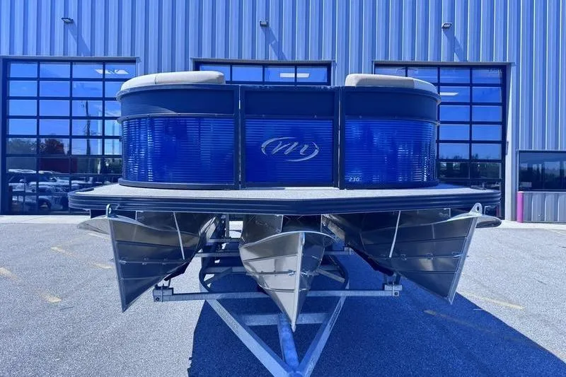 Slide: The Image of 2027 Manitou Aurora 23 RF SHP pontoon boat in front of a modern building. - 6