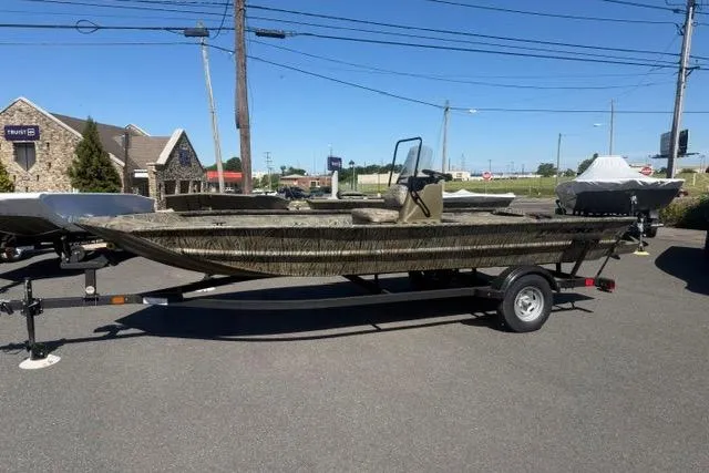 Slide: The Image of 2026 Tracker Grizzly 1860 CC boat on trailer in outdoor setting. - 66