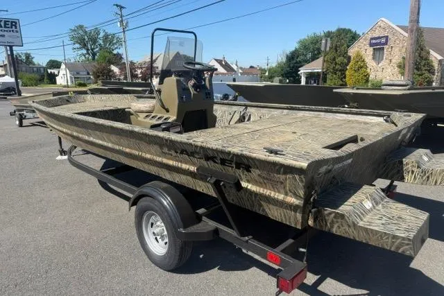 Slide: The Image of 2026 Tracker Grizzly 1860 CC boat on trailer, camo design, parked outdoors. - 3