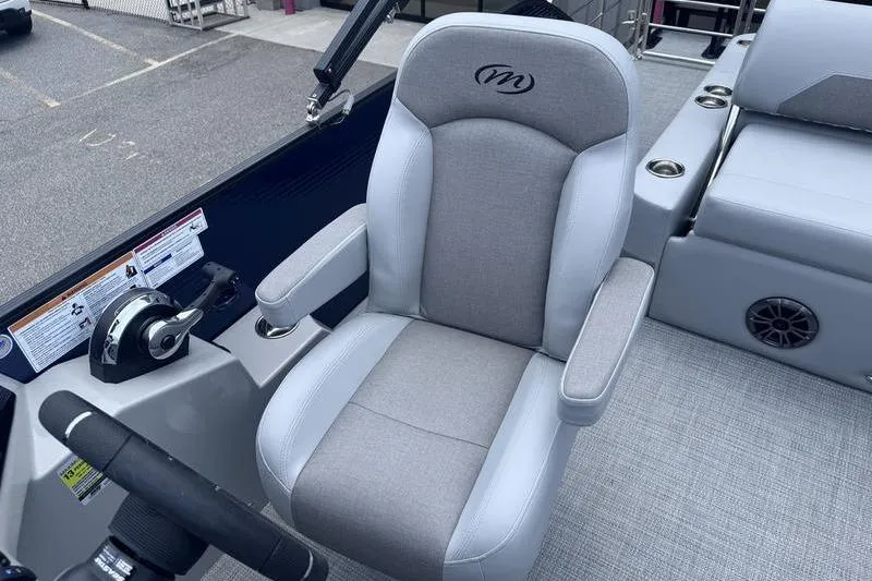Slide: The Image of Captain's chair in 2027 Manitou Aurora 23 SL SHP boat, featuring sleek design and controls. - 11