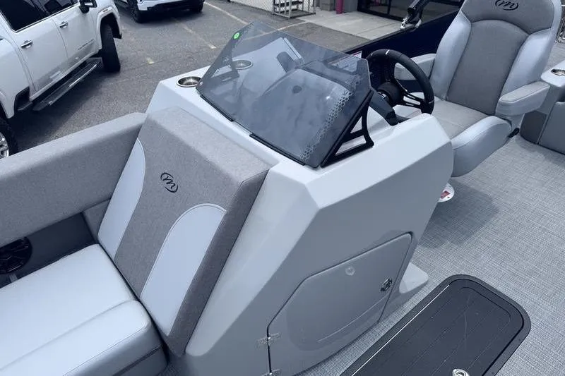 Slide: The Image of 2027 Manitou Aurora 23 SL SHP boat interior with modern helm and seating. - 16