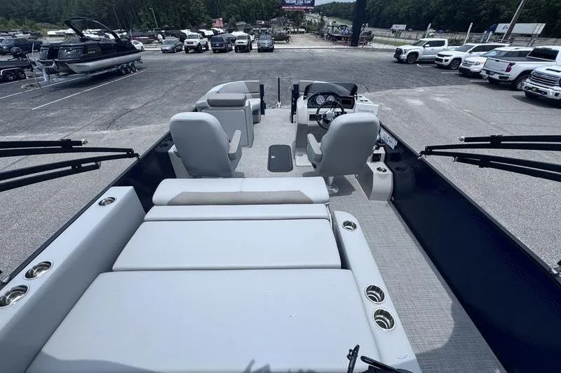 Slide: The Image of 2027 Manitou Aurora 23 SL SHP pontoon boat interior with seating and steering console. - 3