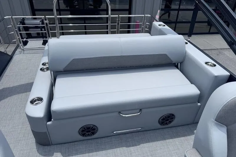 Slide: The Image of 2027 Manitou Aurora 23 SL SHP boat interior with gray seating and cup holders. - 28
