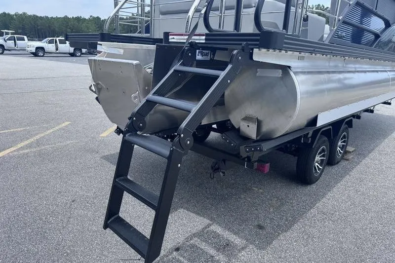 Slide: The Image of 2027 Manitou Aurora 23 SL SHP pontoon boat with rear ladder and dual-axle trailer. - 19